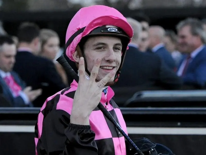 Melbourne jockeys premiership leader Beau Mertens Jockey Beau Mertens holding up three fingers
