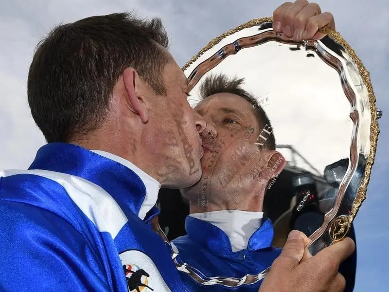 Hugh Bowman kisses the Cox Plate after Winx's history-making win. Hugh Bowman and the Cox Plate trophy.
