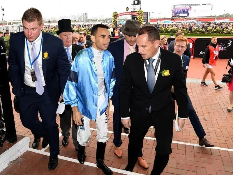 Trainer Chris Waller (right) walks with Joao Moreira after the jockey's Melbourne Cup day fall. Joao Moreira escaped serious injury in a fall at Flemington.