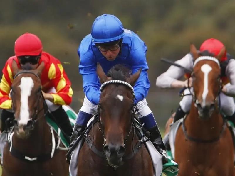 Jockey Kerrin McEvoy (centre) rides Gongs to win race 1.