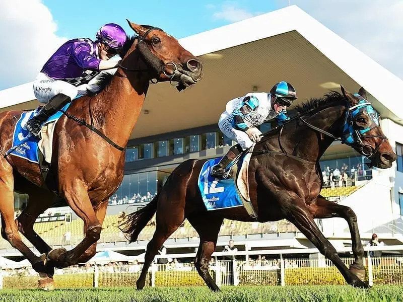 Jockey Jim Byrne rides Ruling Dynasty (right) to victory.