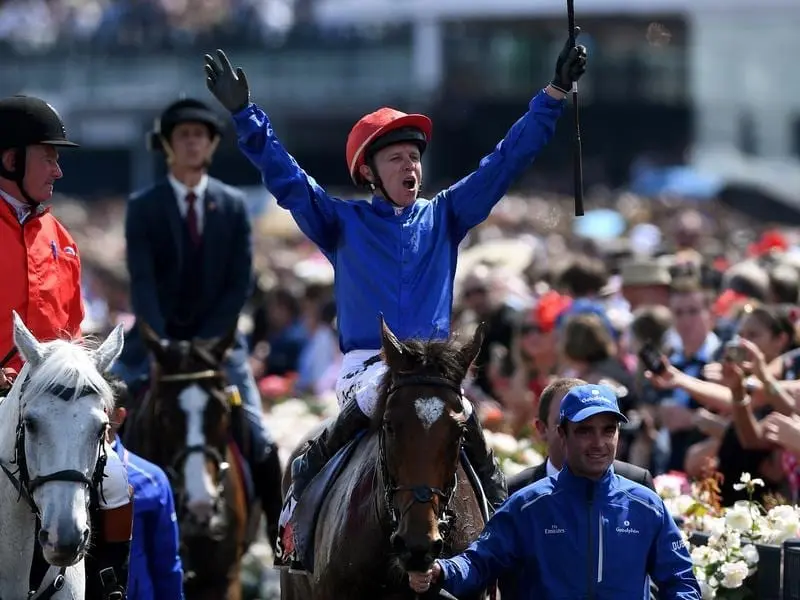 Jockey Kerrin McEvoy celebrates as he returns to the mounting yard.