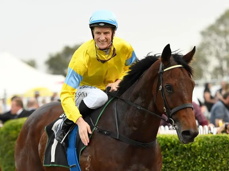 Jockey Blake Shinn pats Man Booker after their win in Ipswich