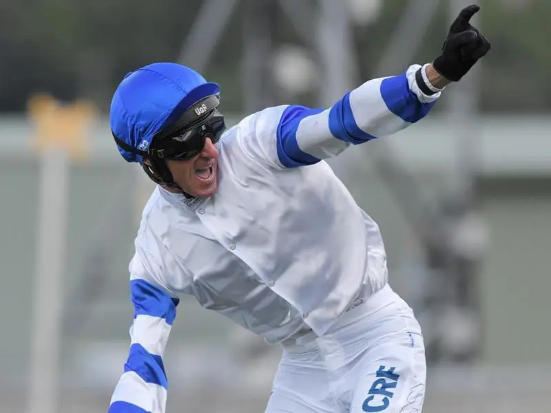 Glen Boss salutes after winning the Epsom Handicap on Kolding.