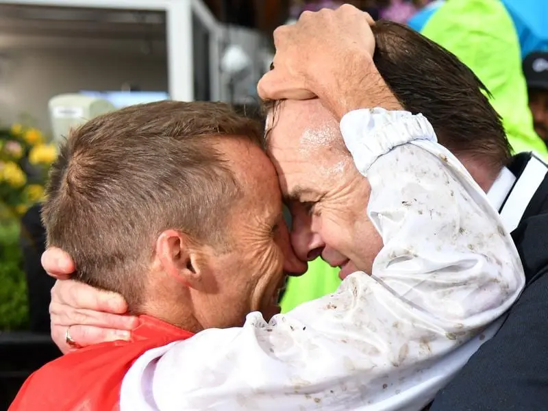 Jockey Damien Oliver (L) with part owner John O'Neill