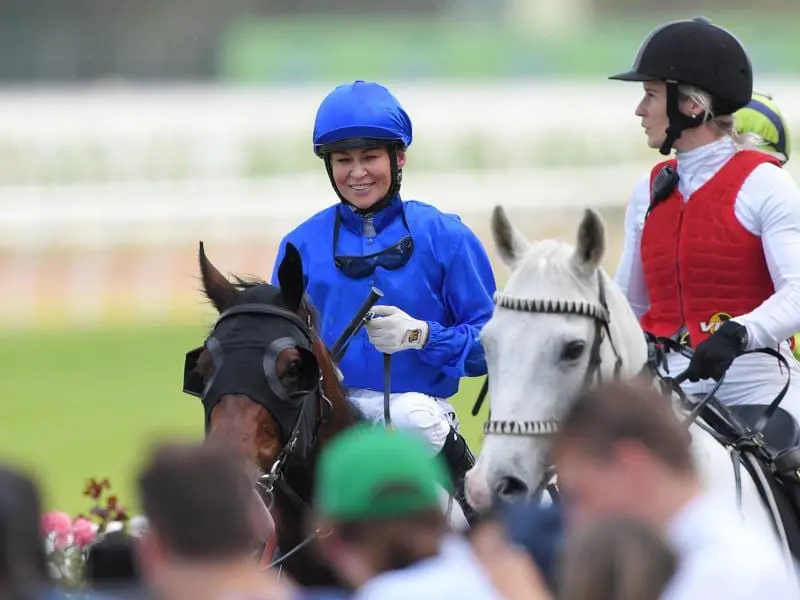 Jockey Kathy O'Hara returns to scale after riding Ranier to victory.