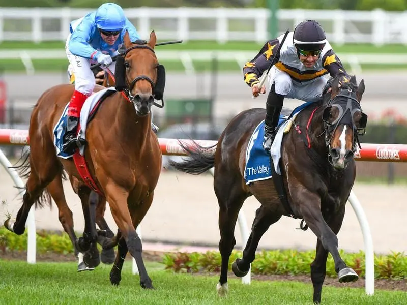 Jockey Brett Prebble rides It's Kind Of Magic (right) to victory