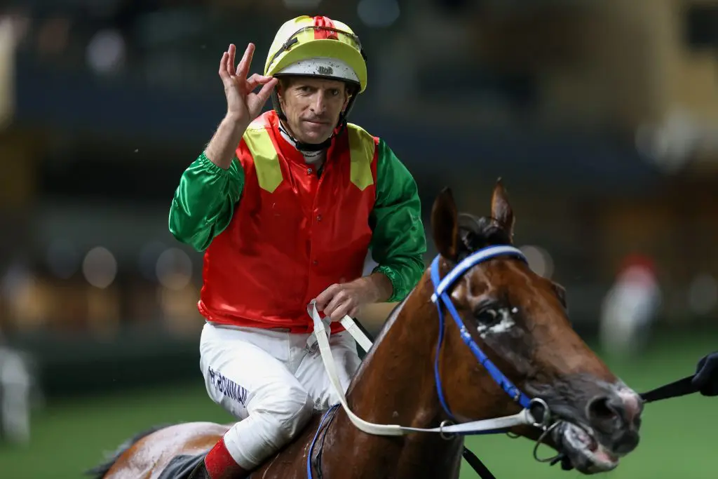 Hugh Bowman celebrates Happy Valley treble