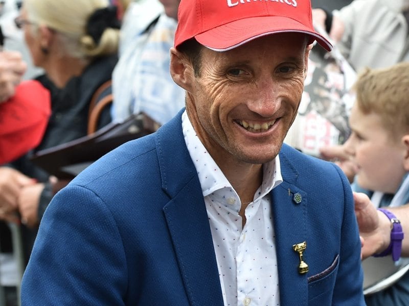 Jockey Damien Oliver is seen with fans during the Melbourne Cup Parade in Melbourne, (AAP)