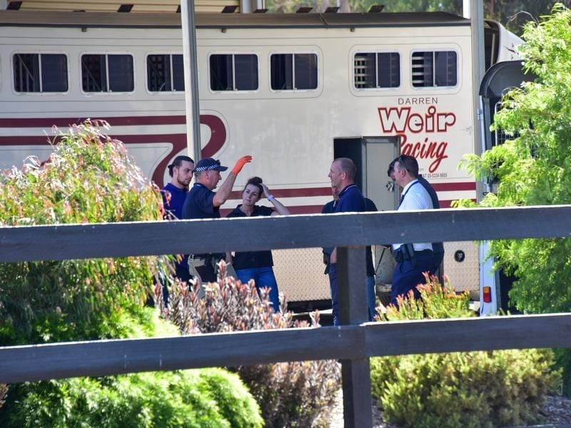 Police are seen at Darren Weir Stables in Miners Rest, Victoria
