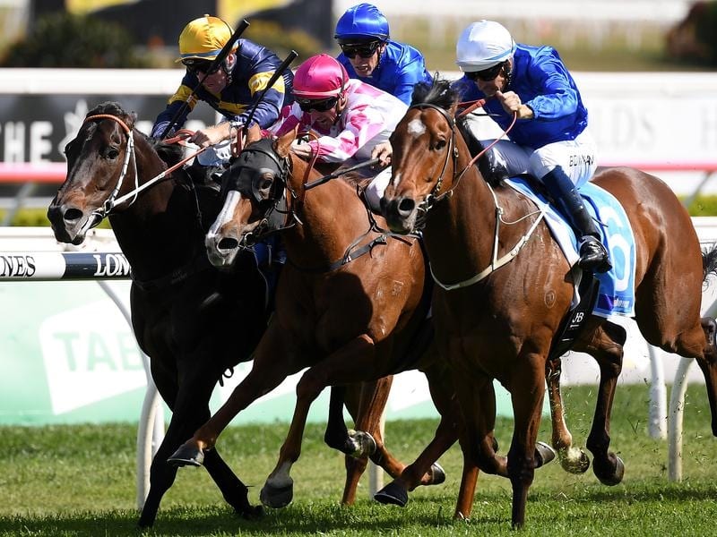 Deprive (right) wins the Sydney Stakes in a three-way finish.
